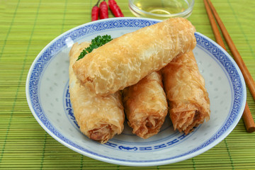 several spring rolls in a dish