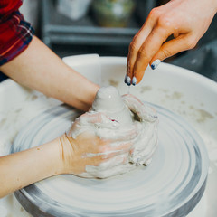 Women making ceramic pottery, concept for workshop and master class, four hands close-up, focus on...