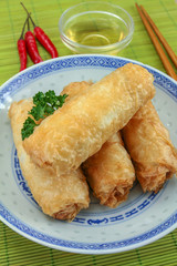 several spring rolls in a dish