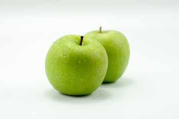 Fresh green apples on a white background isolated.