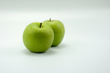 Fresh green apples on a white background isolated.