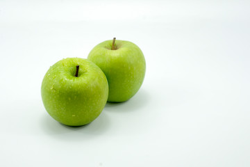 Fresh green apples on a white background isolated.