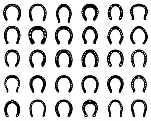 Black silhouettes of horseshoe on a white background - 308754832