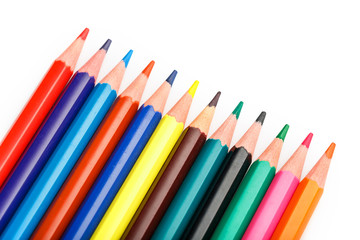 Colored pencils in a row on a white background, free space for text.