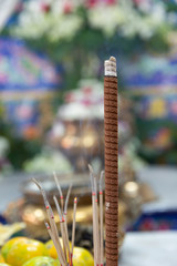 Incense sticks and candles on joss stick pot are burning and smoke use for pay respect