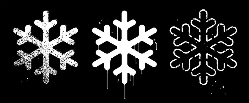 Vector set of abstract snowflakes. Grunge urban style. White imprints on a black background. Distressed sponged texture, paint streaks and splatter. Rough symbols of harsh winter and dangerous frost
