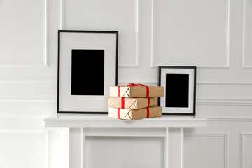 Christmas time in home and fireplace. Free space for your decoration and empty frames.Xmas decoration and white wall background. 