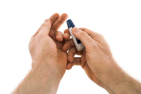 The lancing device is directed to the tip of the finger from which blood will be taken for analysis for diabetes