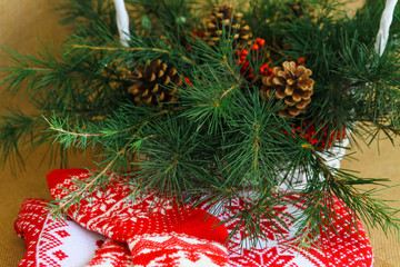 Winter, Christmas decor with pine branches, woven basket, conifer cones, columbian cones, on wooden background