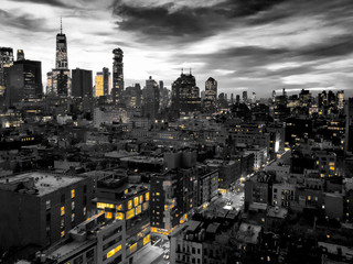 New York City skyline view at night with yellow lights contrasted against the black and white buildings of Manhattan - Powered by Adobe