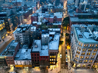 Overhead view of the busy streets of Nolita and SoHo neighborhoods with colorful night lights...