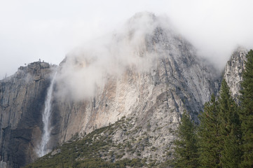 Winter landscape of Upper Yosemite Falls in fog captured with motion blur, Yosemite National Park, California, USA