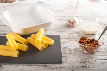 The process of making pasta. Raw cannelloni pasta on a light table close-up and copy space.