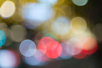 A background of colored light dots creating bokeh at night