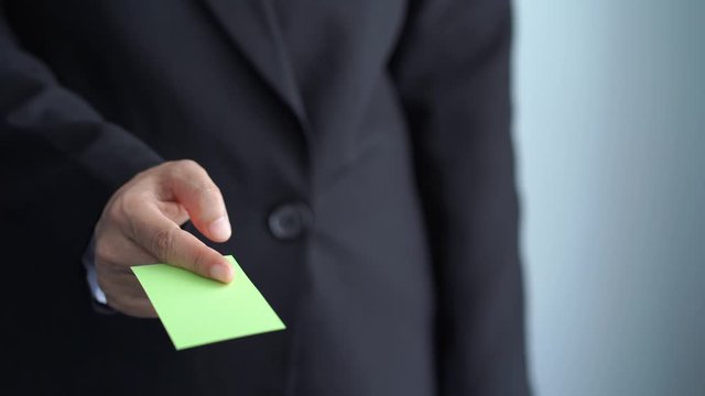 businessman handing name card to introduce himself, green screen mockup
