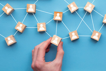 Hand choosing a wooden block from a set. Business choice concept