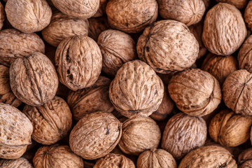 walnuts, unpeeled greek nuts, harvest of walnuts, walnuts closeup, background with walnuts,organic delicious nuts. healthy snack.