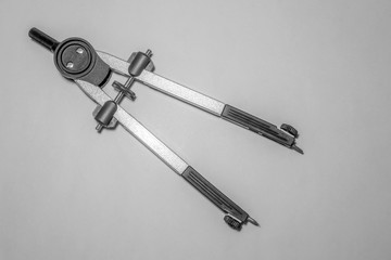 compass on gray background black and white