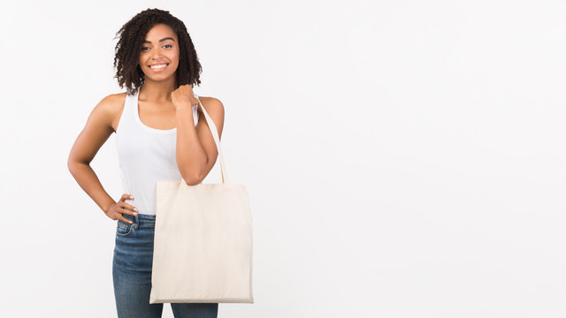 Afro woman with blank eco sack on white background