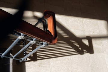 Blurry contours shadows of metal railing on marble stone stairs of building