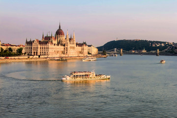 Fototapeta na wymiar BUDAPEST, HUNGARY JULY 29, 2019: evening view on Hungarian Parliament and Danube River with cruise ships
