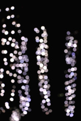 Defocused Christmas background with blue, silver adn white bokeh lights.