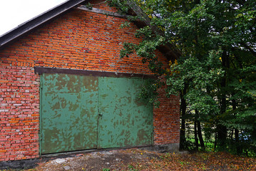 Old green metal rusty brick garage door