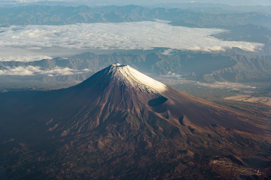 A birds eye view close-up the Mount Fuji ( Mt. Fuji ) and blue sky. Scenery landscapes of the Fuji-Hakone-Izu National Park. Shizuoka Prefecture, Japan