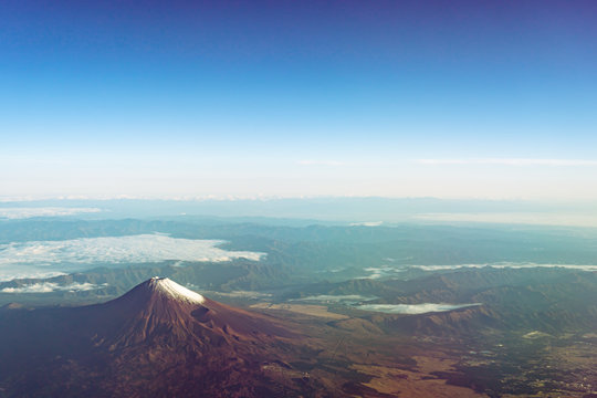 A birds eye view close-up the Mount Fuji ( Mt. Fuji ) and blue sky. Scenery landscapes of the Fuji-Hakone-Izu National Park. Shizuoka Prefecture, Japan