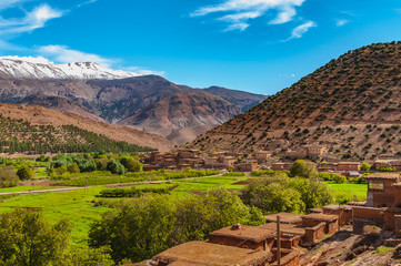 View of adobe house village in the high snow-capped mountains in the Aït Bouguemez valley in Morocco © Nicolas VINCENT