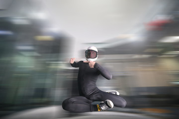 One finger. Fly men show one finger. Sky diver in black suit. Teampleat skydiver.