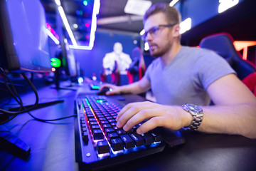 Professional player in computer games sits powerful in club, participates cyber championship