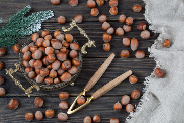 in an old vase hazelnuts, spruce branch and nut cracker