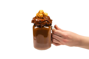 Chocolate milkshake with whipped cream, cookies, waffles, served in glass mason jar. 