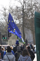 People walk behind the EU flag on the way to an anti-Brexit rally