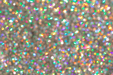Blurred background with holographic sparkles and lights.