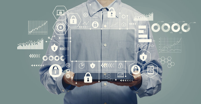 Cyber security theme with young man holding a tablet computer