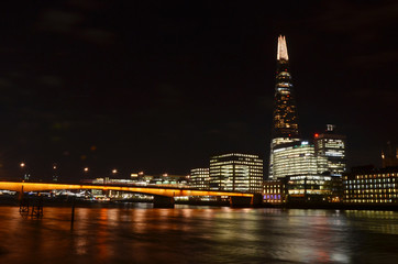 London skyline panorama at night with light reflections