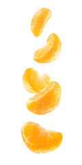 Pieces of peeled mandarin in the air isolated on a white background. Mandarin segments isolated....