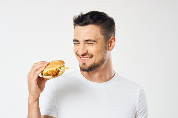 man eating hamburger isolated on white