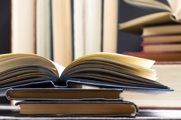 Naklejka premium Open book, hardback books on wooden table. Back to school. Copy space
