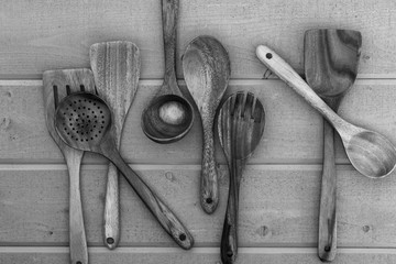 black and white wooden spoons on wood background