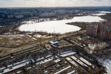 flight over the city and the frozen lake on a winter day (photo from a drone)