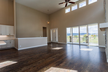 Great room with clerestory, high ceiling, window-wall, and sliding glass doors in an open floorplan home