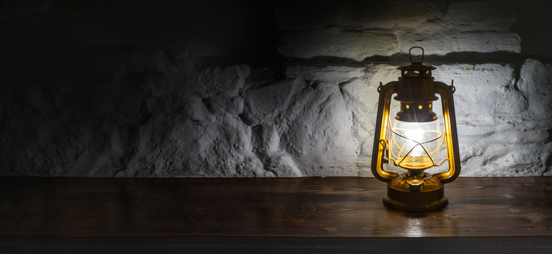 A kerosene lamp on an old wooden background