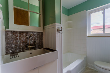 Traditional vintage bathroom with antique trim, modern sink, and wainscotting