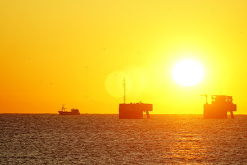 sunrising on mediterranean sea with shipyard