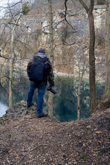 Naklejka premium A photographer scans the blue water of France park looking for his next shot. Located in Logansport Indiana 