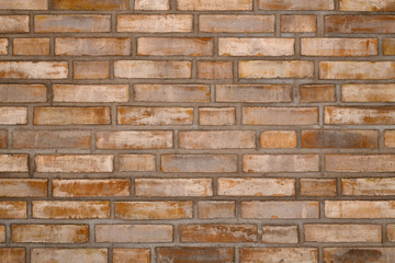 brick wall orange-gray with spots of scratches, interesting in appearance