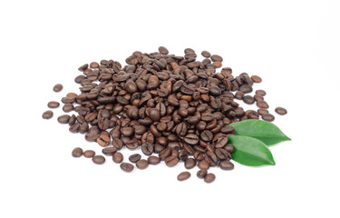 Coffee beans and green leaves on a white background.